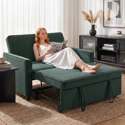 The dark green sleeper sofa in a living room with a woman sitting on it