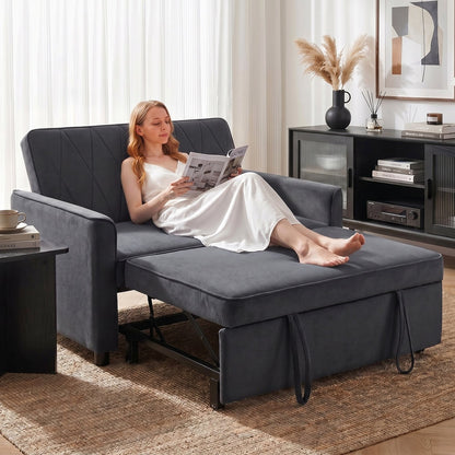 Woman reading on the dark grey 2 seater sofa bed, with the footrest pulled out