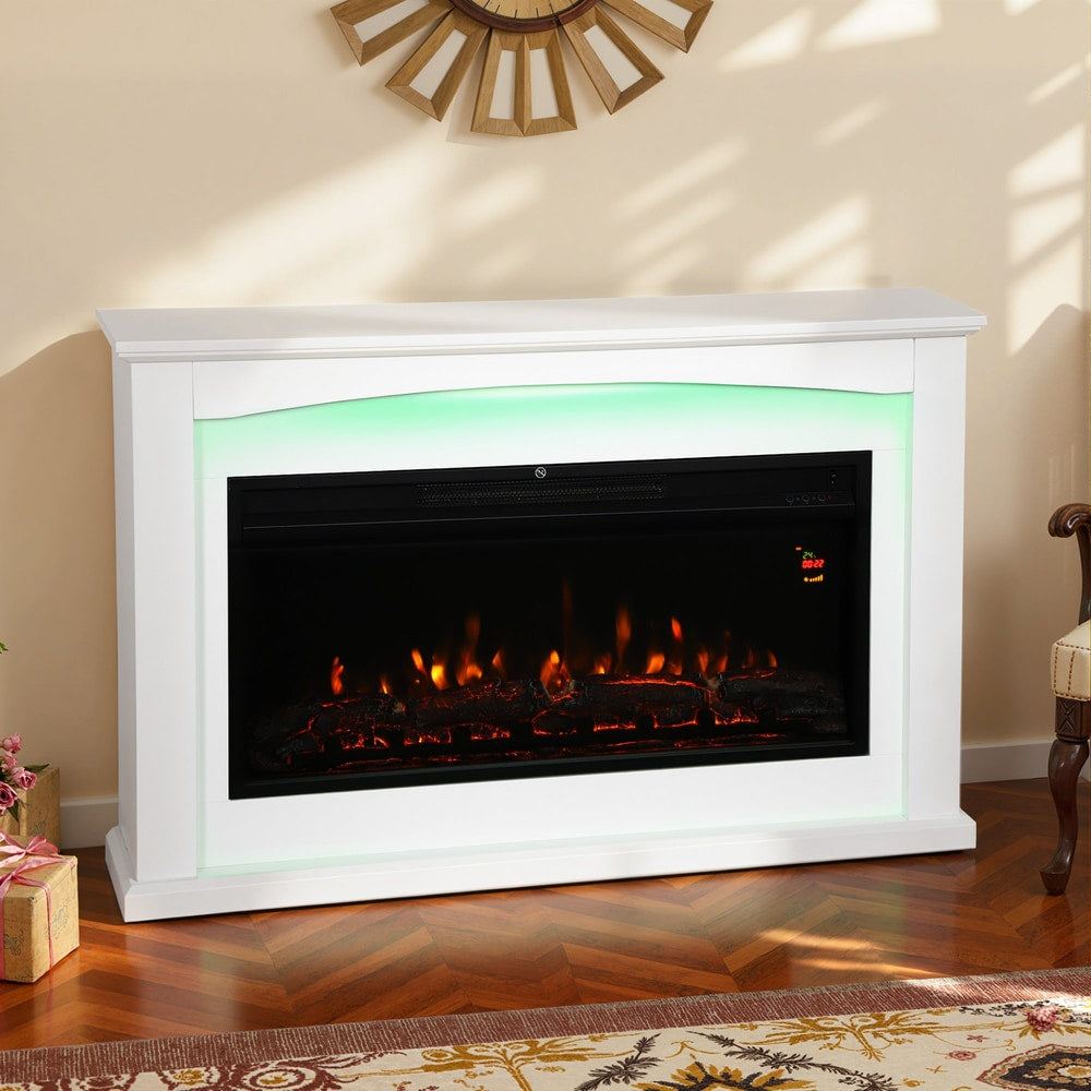 White electric fireplace with a glowing flame effect, set in a cosy room with a decorative wall clock