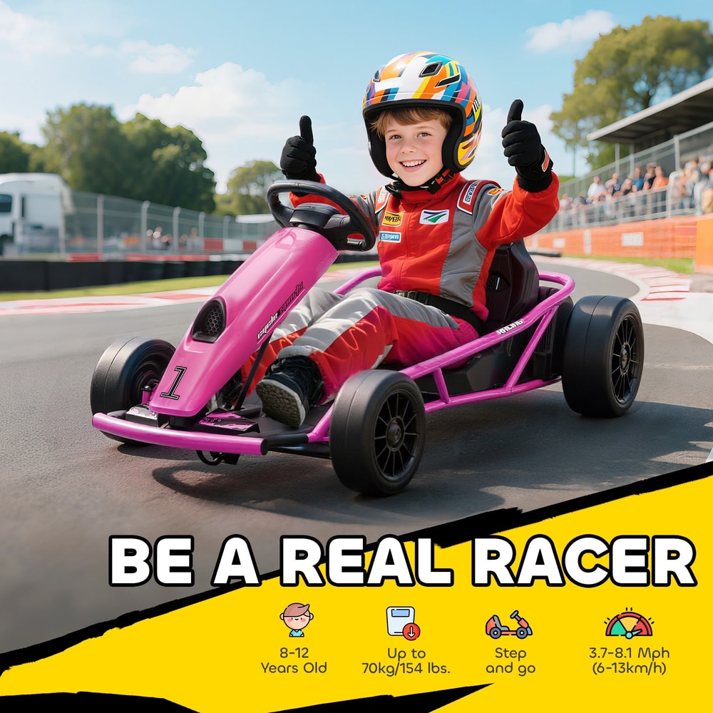 A smiling child in racing gear sitting in the pink ride-on car on a sunny outdoor track