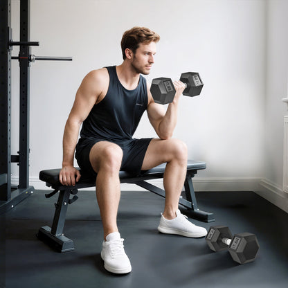 A man sitting on a gym bench lifting one of the rubber hex dumbbells in a home gym setting