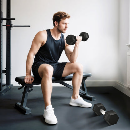 A man sitting on a gym bench using the black dumbbells for a bicep curl exercise