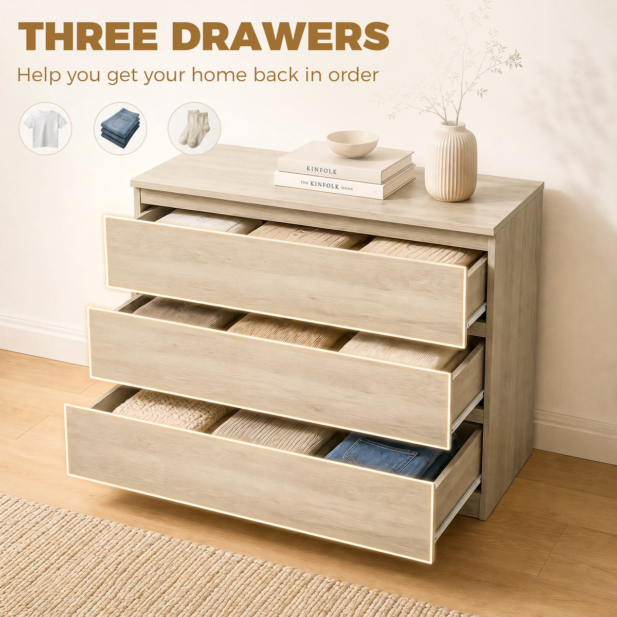 The chest of drawers with all three drawers open and filled with folded clothing
