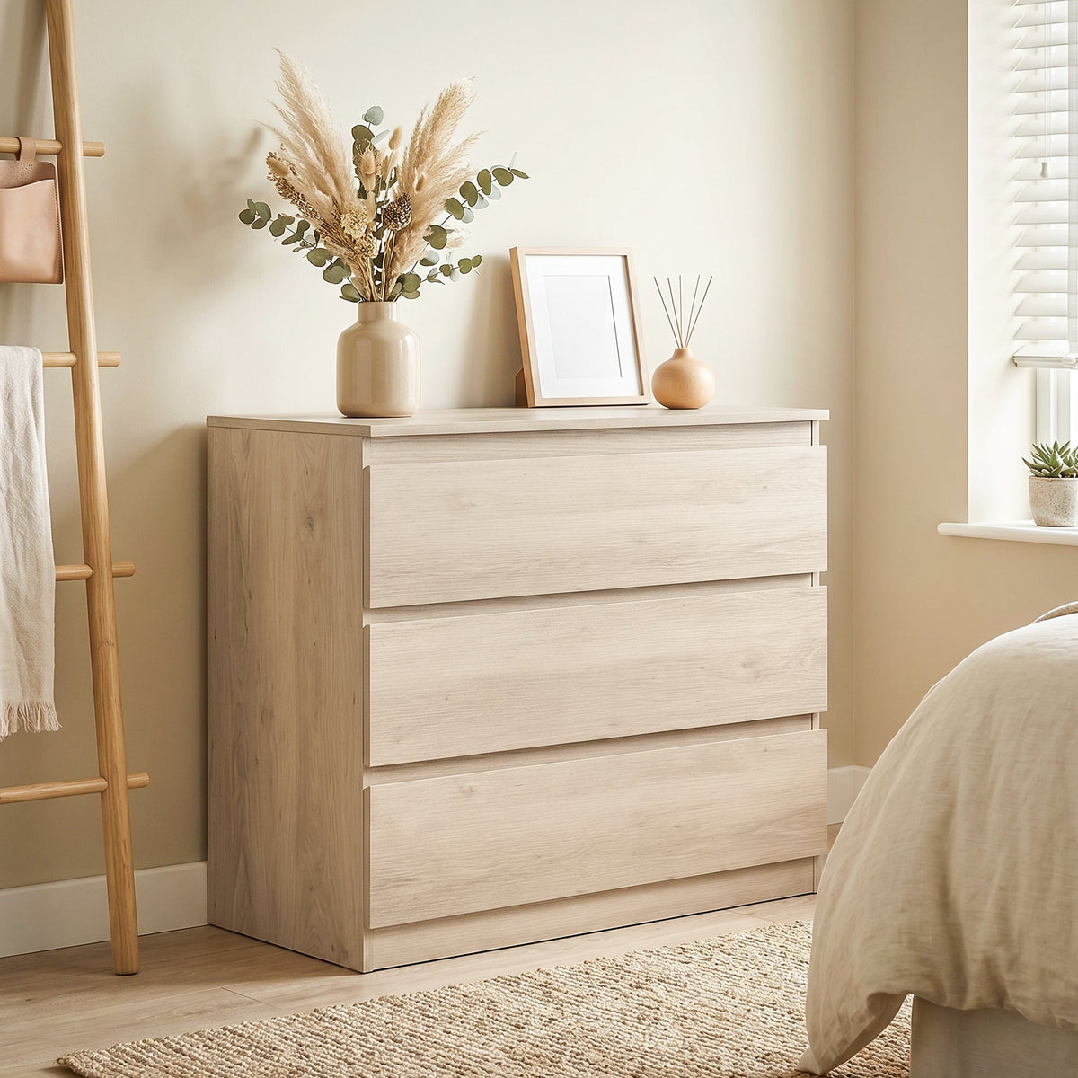 The chest of drawers placed in a bedroom with a vase and picture frame on top