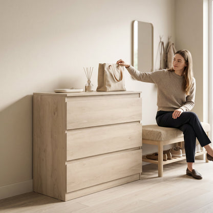 The chest of drawers in a hallway with a woman sitting on a bench next to it