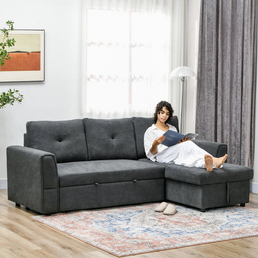 A woman reads a book while relaxing on the dark grey sofa bed in a living room setting