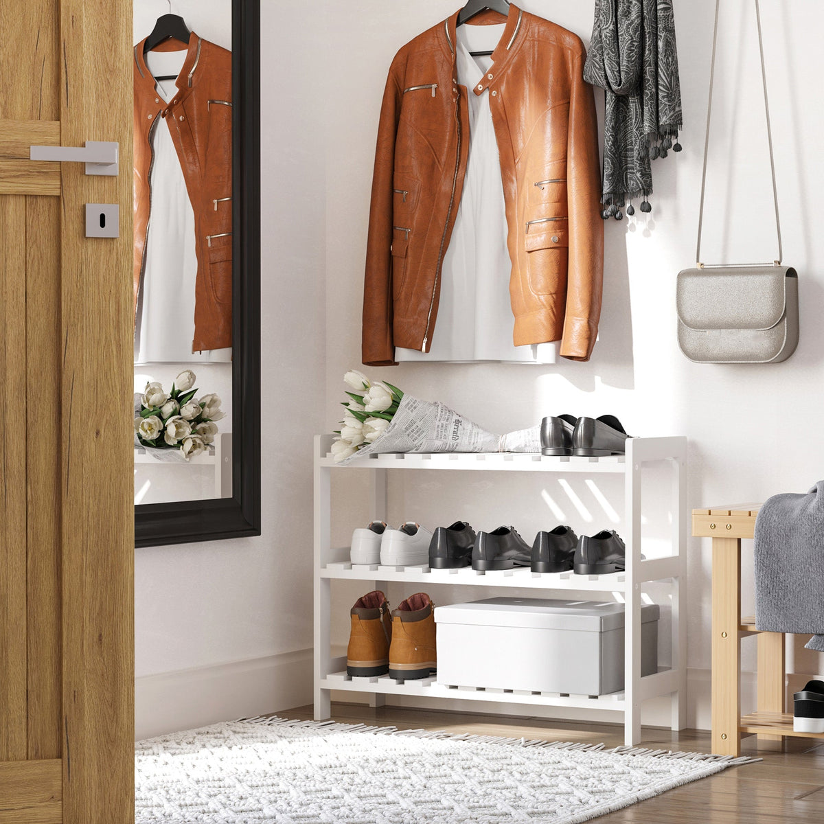 The white shoe storage unit in a hallway with shoes and coats on a rack