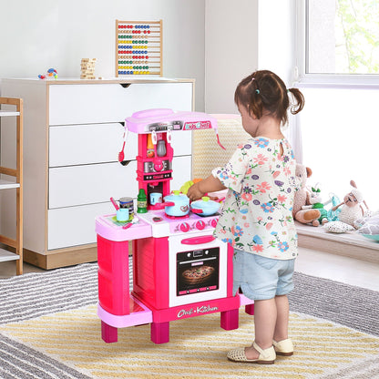 A young child plays with the pink children's kitchen play set in a room