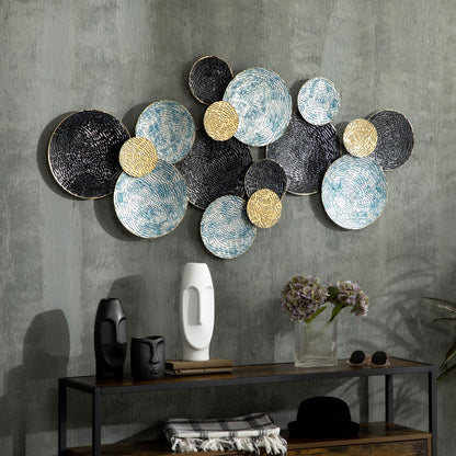 The metal wall art is displayed on a grey wall above a console table with decorative items