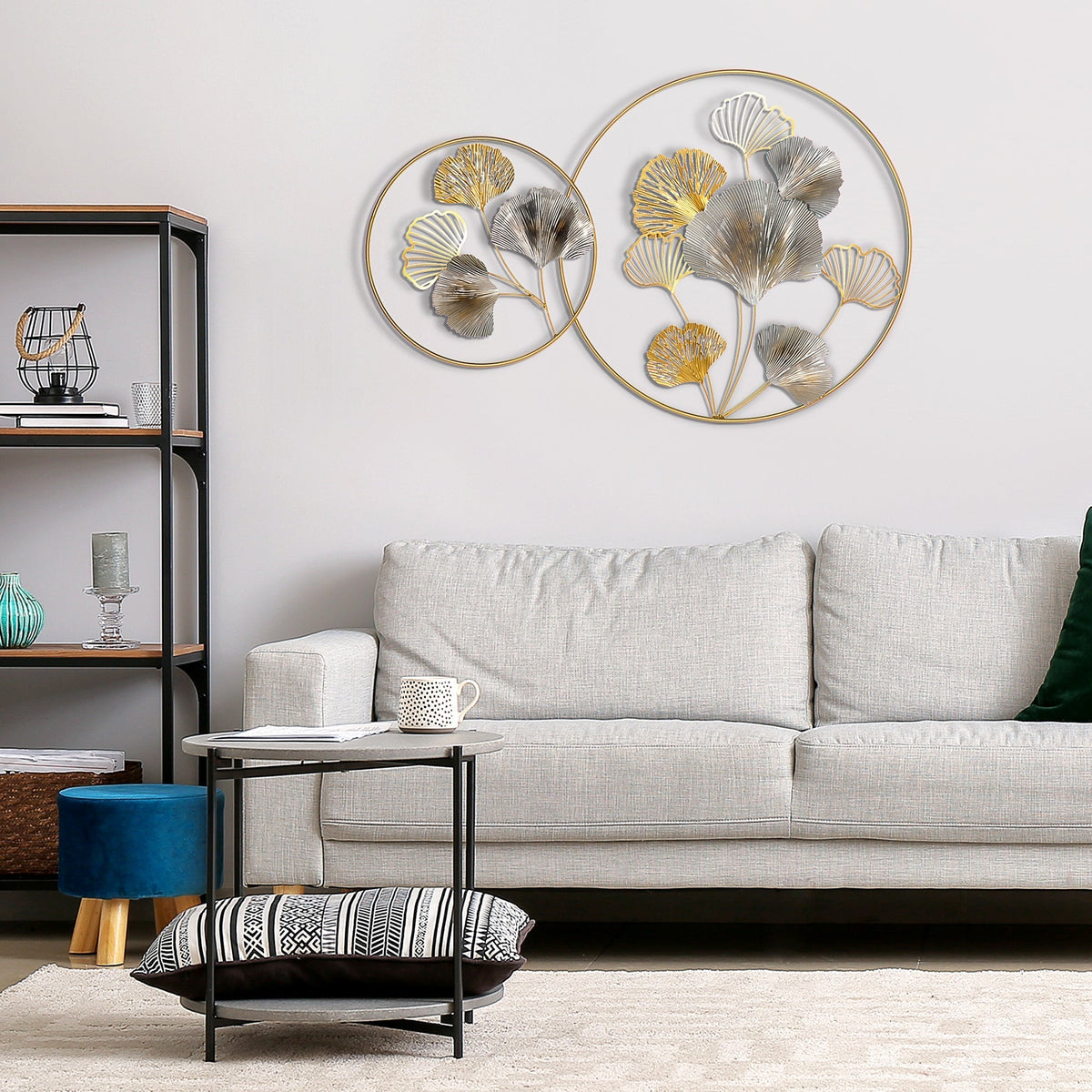 The modern ginkgo leaves wall sculpture in a living room above a sofa