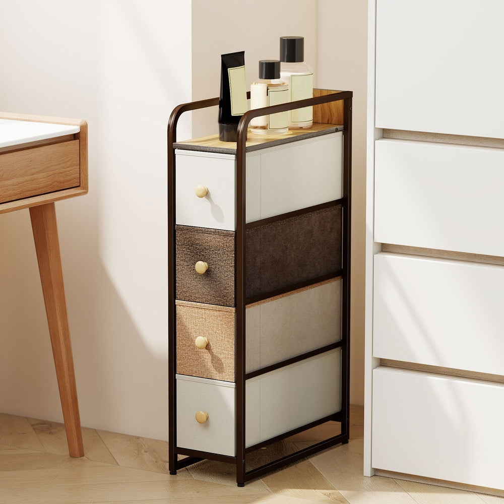 The chest of drawers in a tidy bedroom next to a desk and wardrobe
