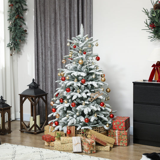 The flocked Christmas tree is decorated with baubles and gifts piled around its base in a room