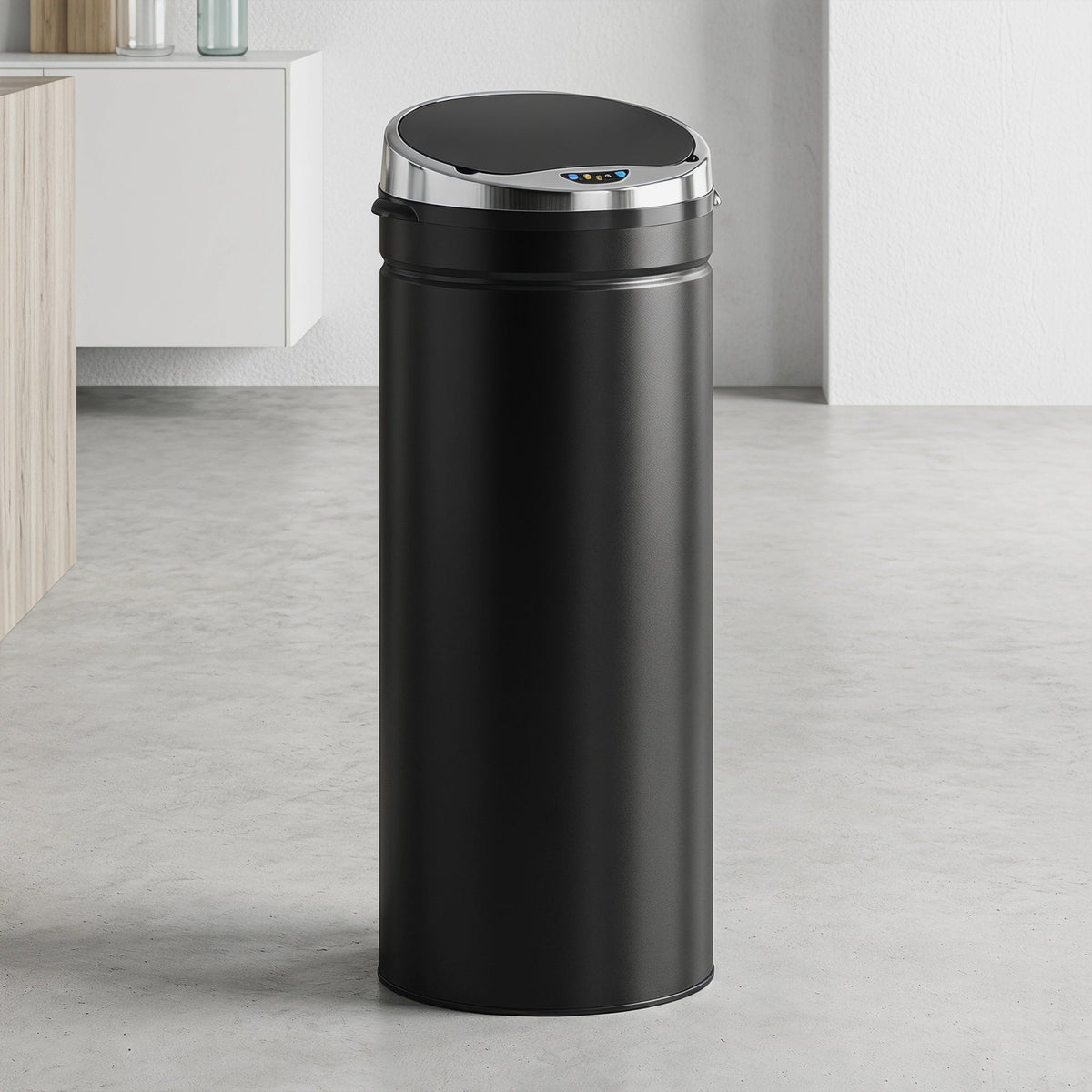 The black automatic sensor bin shown in a modern kitchen setting with the lid closed