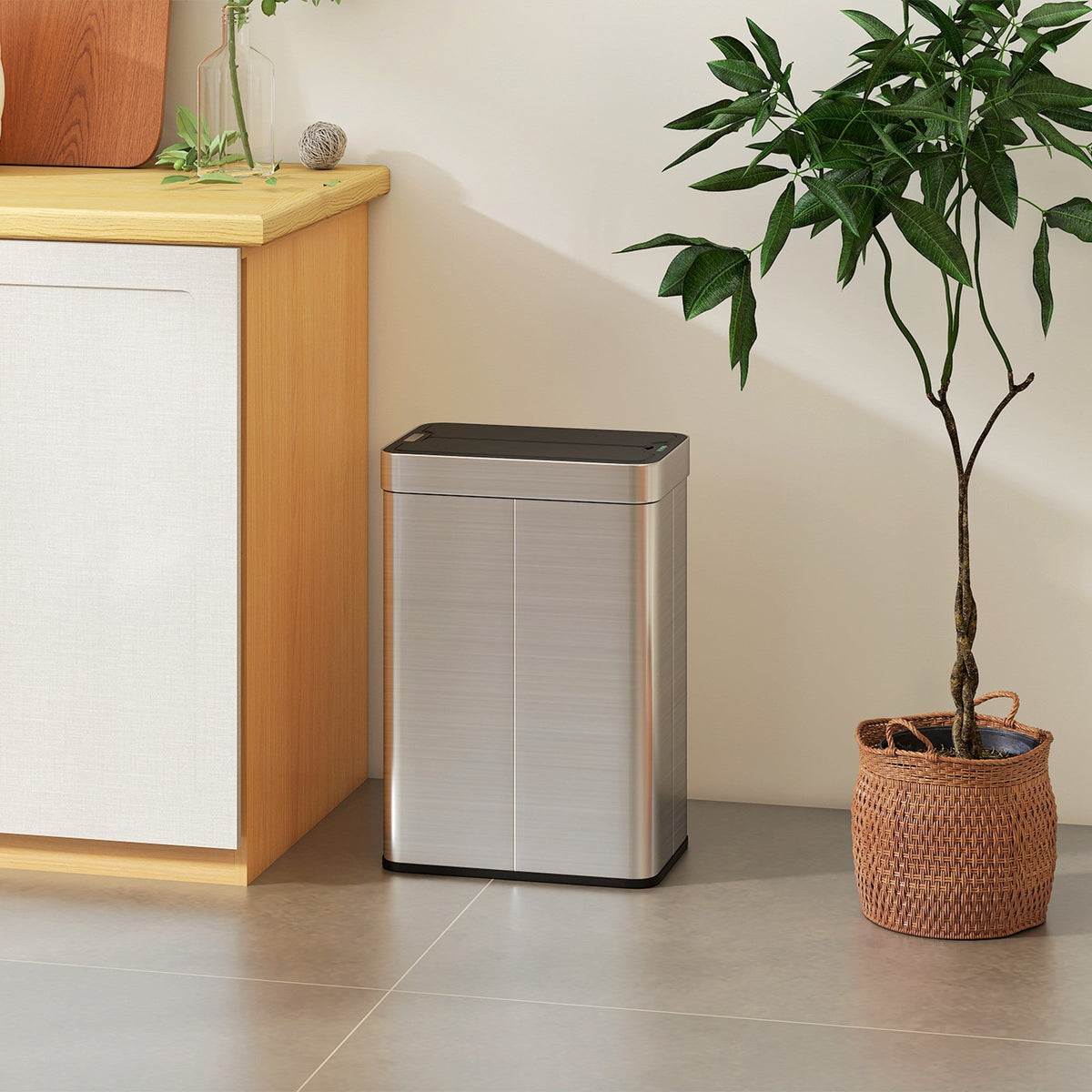 The sensor bin standing on a grey floor next to a wooden cabinet and a potted plant in a kitchen