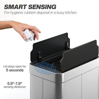 The touchless rubbish bin with its lid open as a hand drops a piece of paper into the container