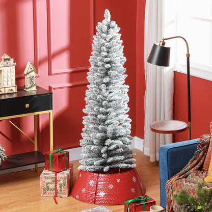 The snowy pencil Christmas tree decorated in a room with presents and a red tree skirt