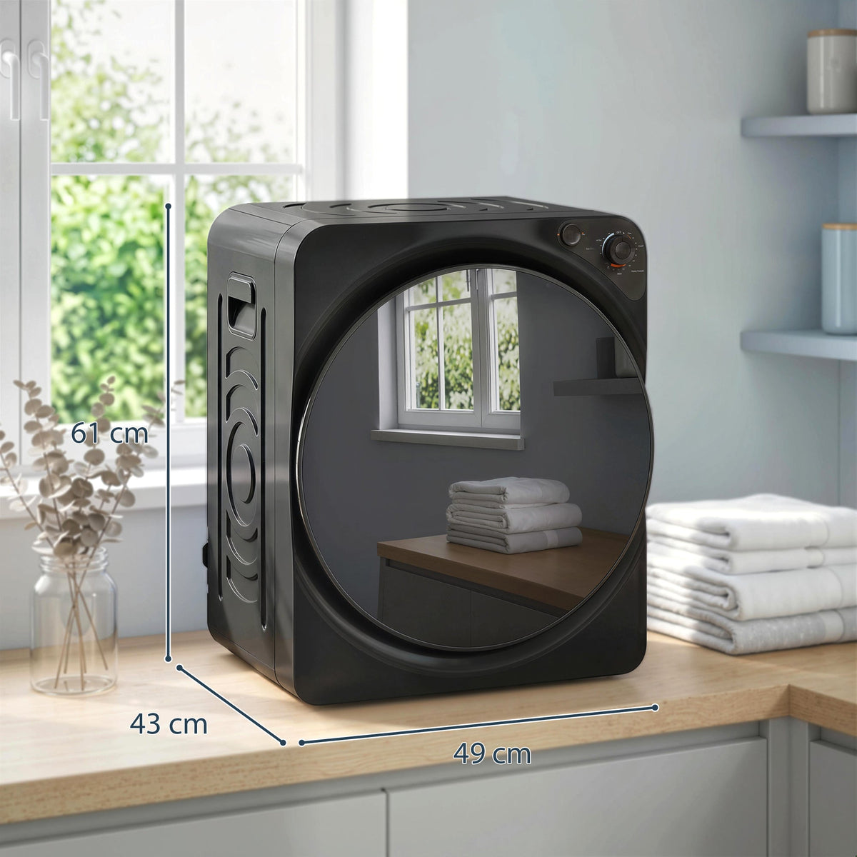 The compact tumble dryer shown with dimensions marked on the exterior