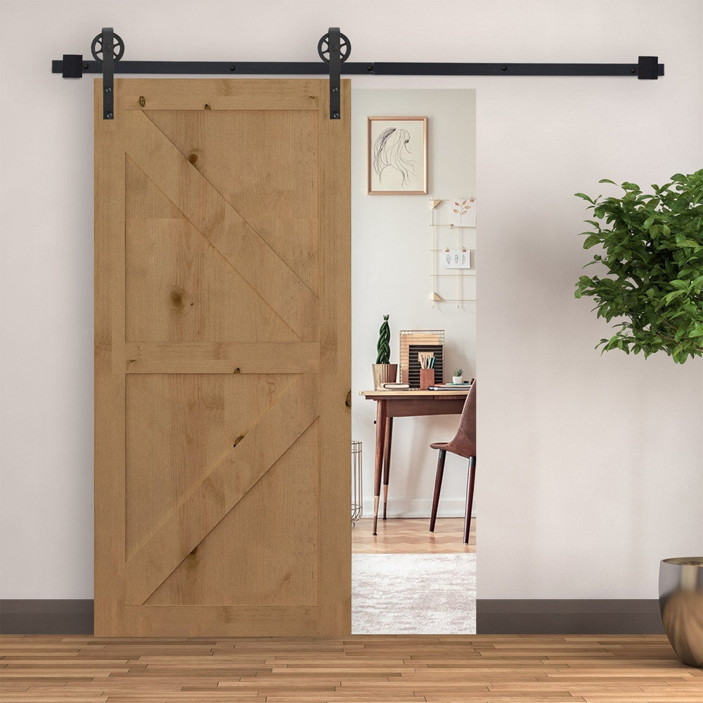 The sliding barn door hardware in use on a wooden door in a room