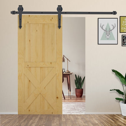 The barn door hardware set installed on a wooden door in a room