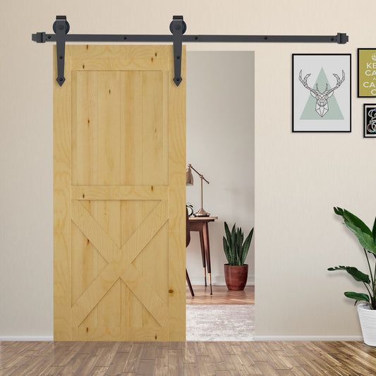 The barn door hardware set installed on a wooden door in a room