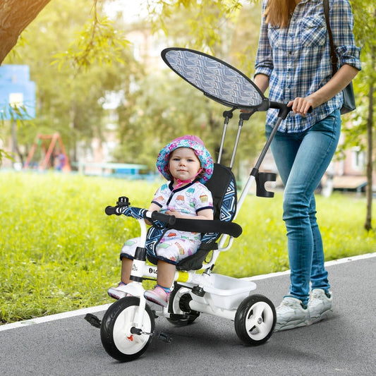 A child sits in the blue and white tricycle with a parent pushing from behind