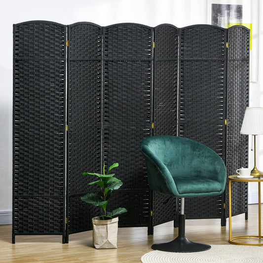 Black six panel folding room divider used to separate a living room area with a chair and plant