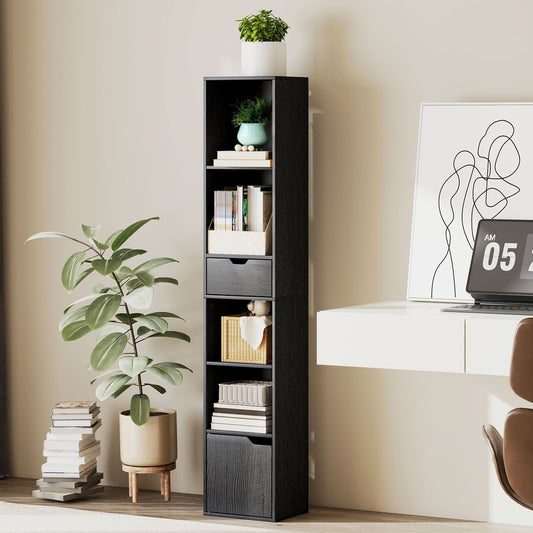 The tall narrow bookshelf is shown in a room next to a desk with plants and books
