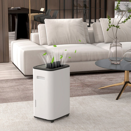 The portable dehumidifier in a modern living room next to a sofa