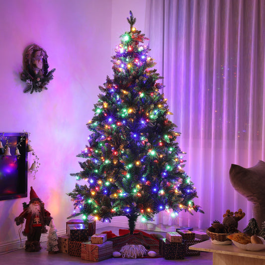 The pre-lit Christmas tree in a room with festive decorations and presents