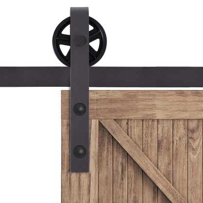 Close-up of the wheel and track hardware for the sliding barn door