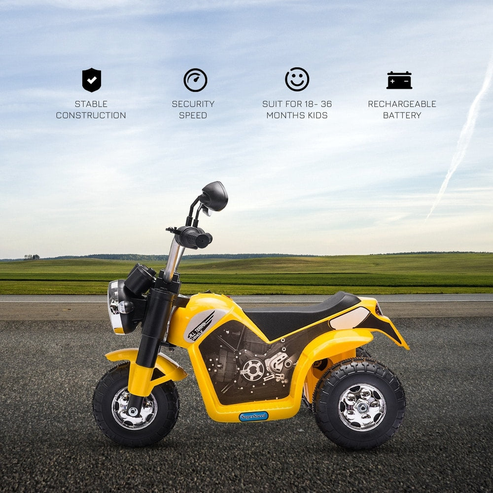 The yellow kids electric motorbike parked on a flat surface with a scenic background