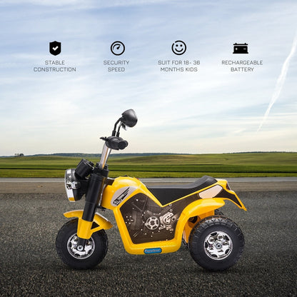 The yellow kids electric motorbike parked on a flat surface with a scenic background