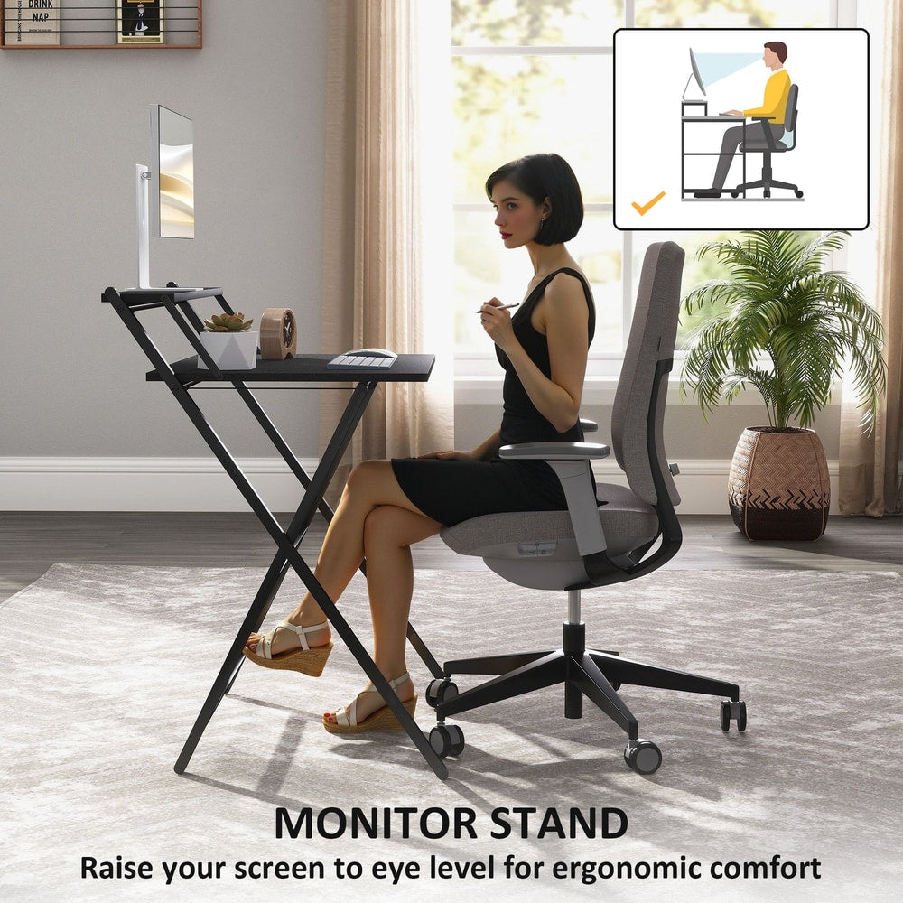 A woman uses the black folding computer desk with a monitor shelf for ergonomic comfort