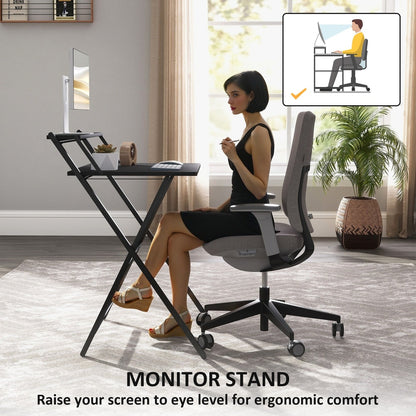 A woman uses the black folding computer desk with a monitor shelf for ergonomic comfort