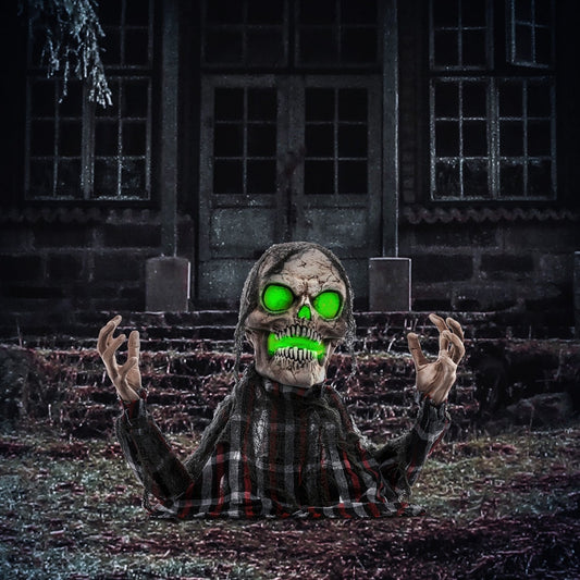 The Halloween skeleton displayed in a dark garden setting in front of an old house