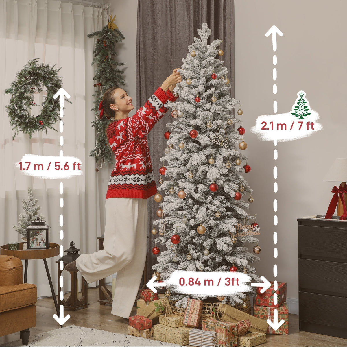 A woman decorating the white Christmas tree with baubles and presents around its base
