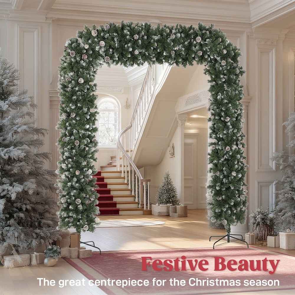 The festive Christmas tree arch in a grand hallway with a staircase