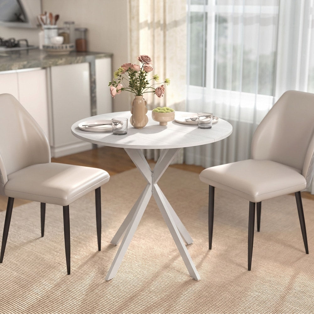 The dining table in a room with two chairs and a vase of flowers on top