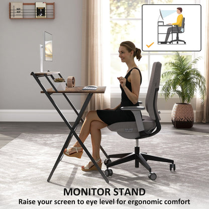 A woman using the folding computer desk with a monitor stand for ergonomic comfort