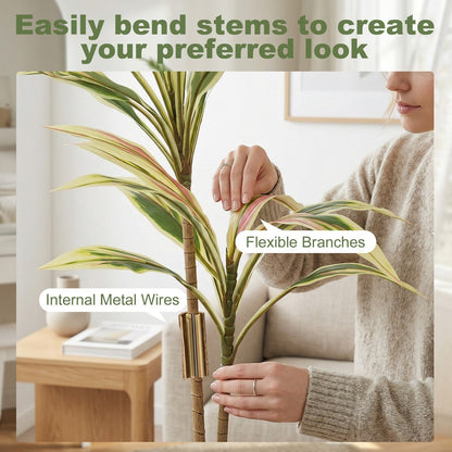 Woman bending the flexible stems of the artificial cordyline tree to shape it