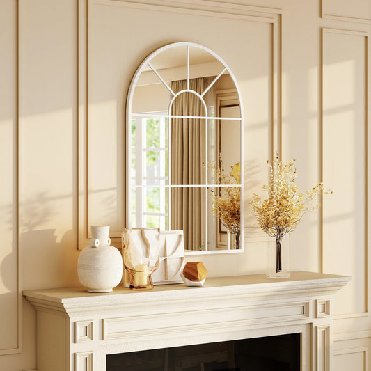 The arched grid mirror is displayed above a fireplace mantelpiece, reflecting a window and curtains