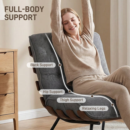 Woman relaxing in the dark grey fabric armchair, showing back, hip and thigh support