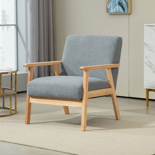 The grey accent chair placed in a bright living room setting with a rug and side table