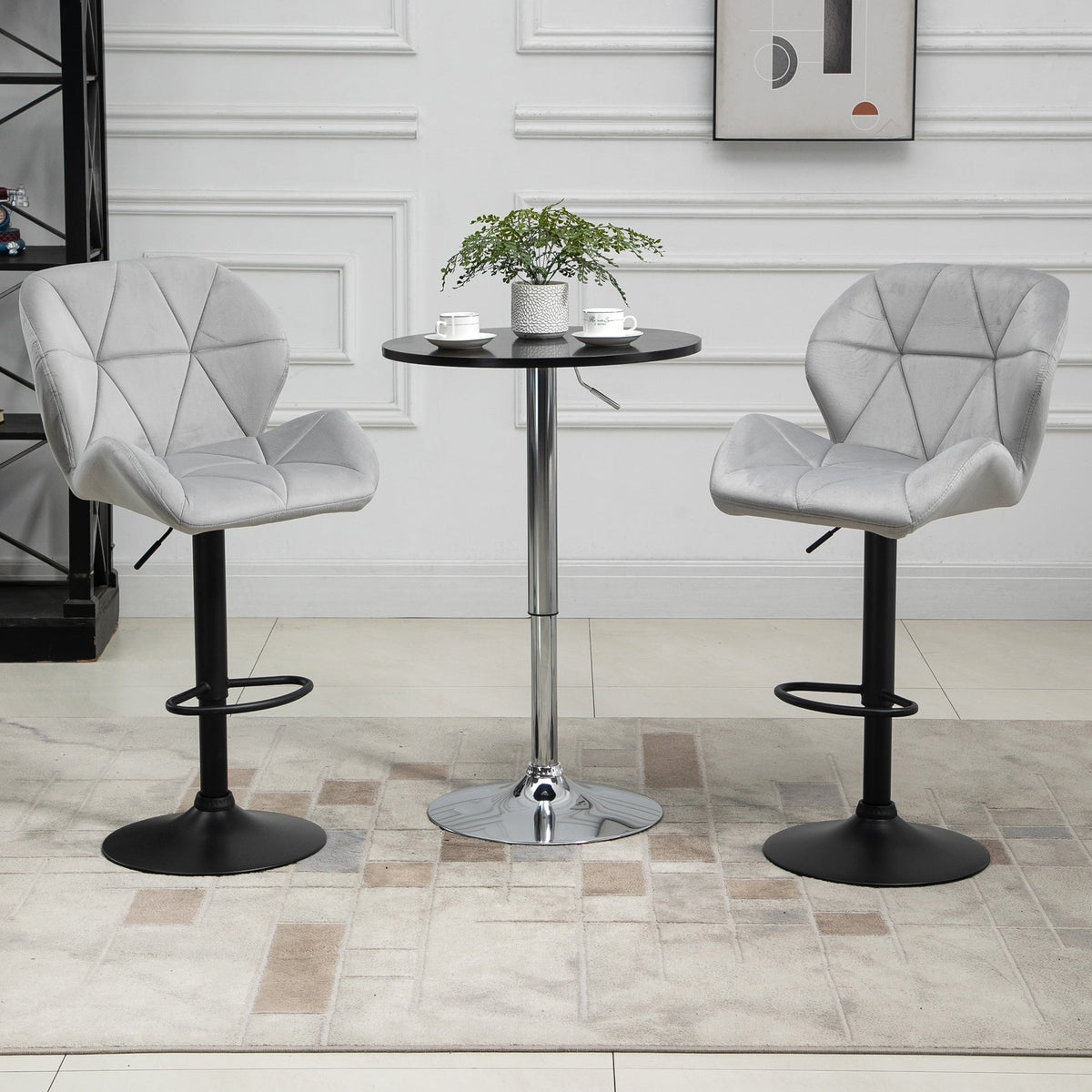 The bar stools placed on either side of a small round table in a bright living room setting
