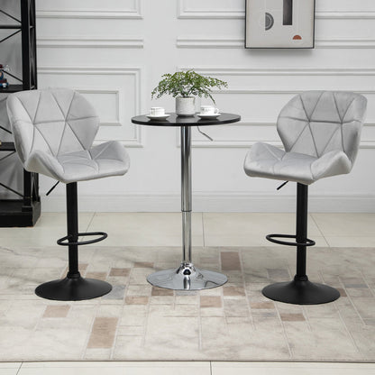 The bar stools placed on either side of a small round table in a bright living room setting