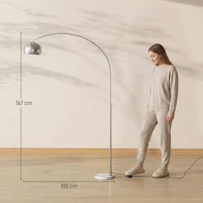 The modern arc floor lamp shown with a woman standing next to it, indicating scale