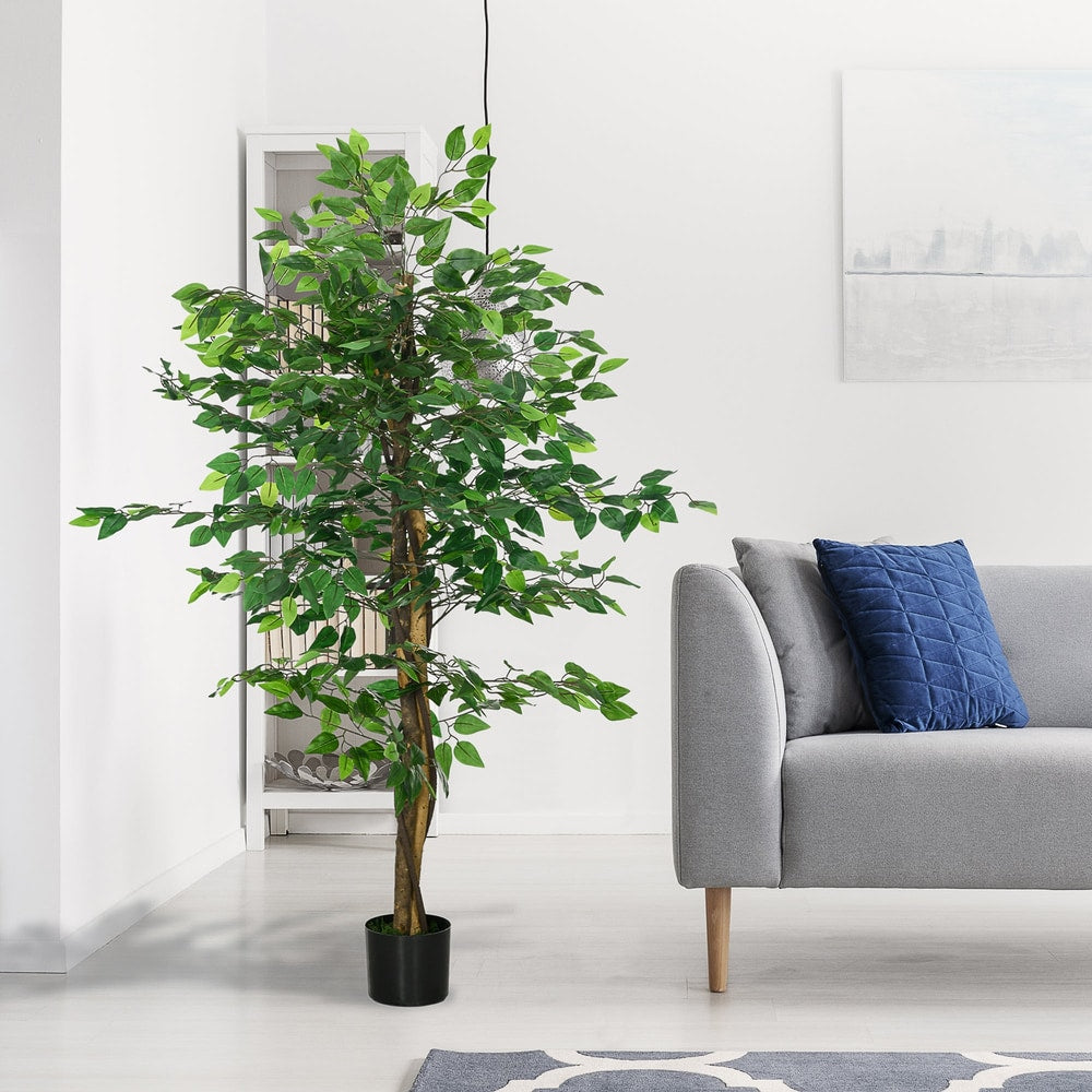 The artificial ficus tree standing in a modern living room next to a grey sofa
