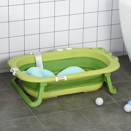 Green foldable baby bath tub with a blue cushion, set against a tiled wall