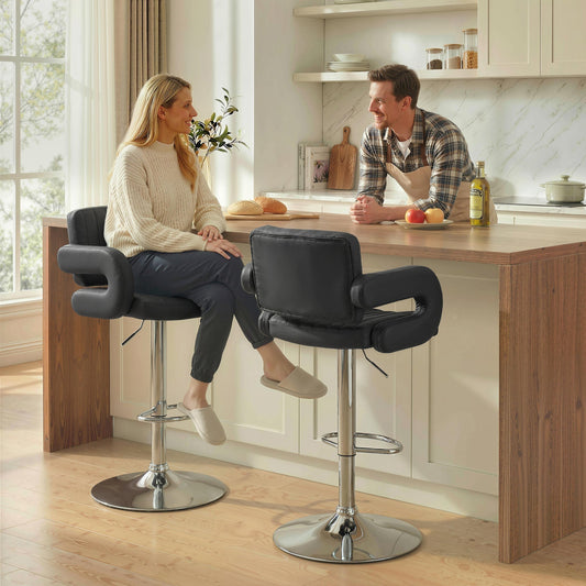 Two black PU leather bar stools with armrests and backrests in a modern kitchen setting