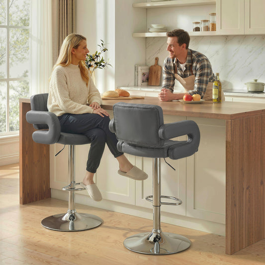 The kitchen chairs placed at a wooden breakfast bar with a couple sitting on them
